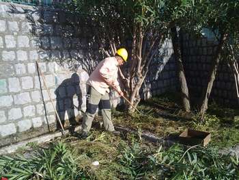 Un operaio forestale impegnato a ripulire un'aiuola
